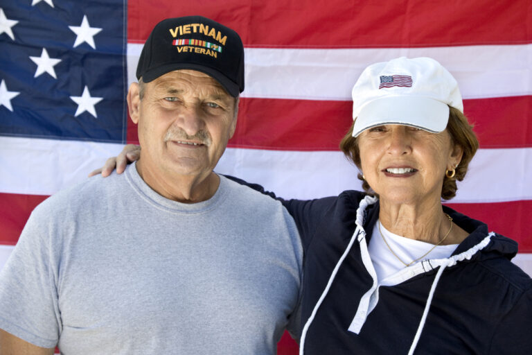 veteran in front of flag