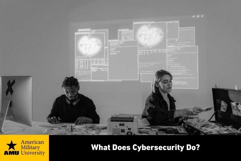 cybersecurity professionals working on laptops